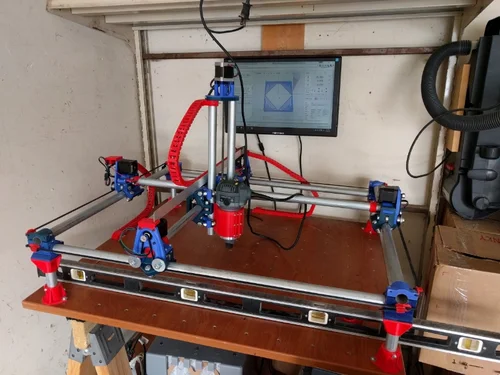 CNC squared and mounted to the work table. Cable chain was printed to hold the motor wiring. Installed Installed