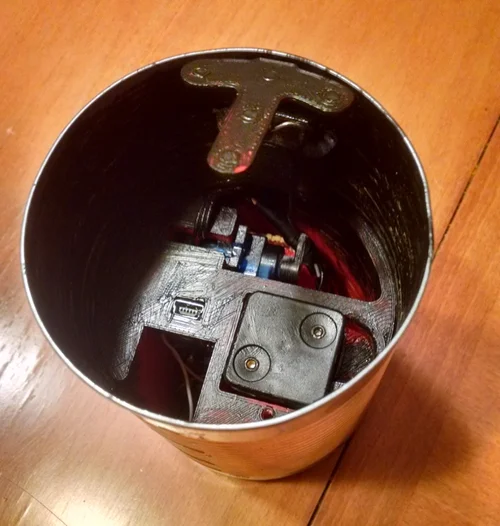 I cut a small hole in the can so it can be discretely turned on and off. The button and hole will be hidden by the label. Paint it Black Paint it Black